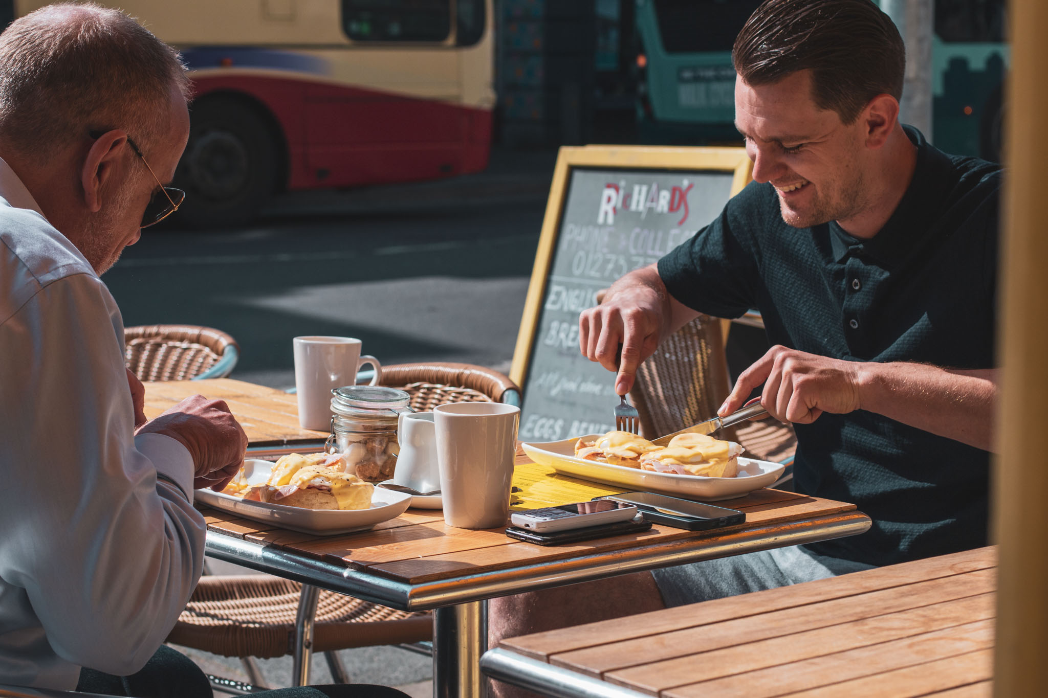 People sitting outside in the sun enjoying breakfast at Richards Cafe